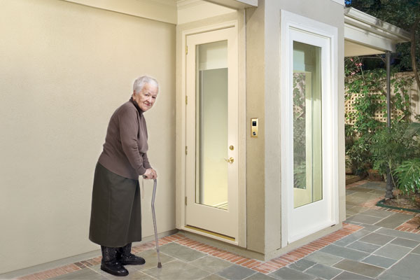 elderly woman standing outside of elevator