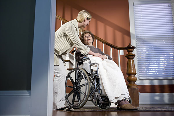 elderly lado on a wheelchair at home